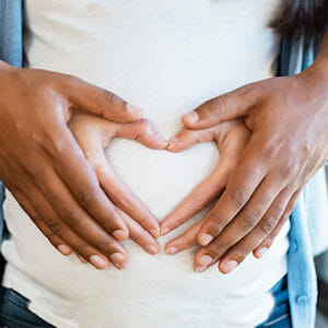 Couple holding female's belly